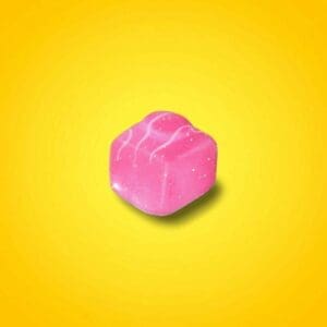 Pink French Fancy Pin Badge on a gradient yellow background.
