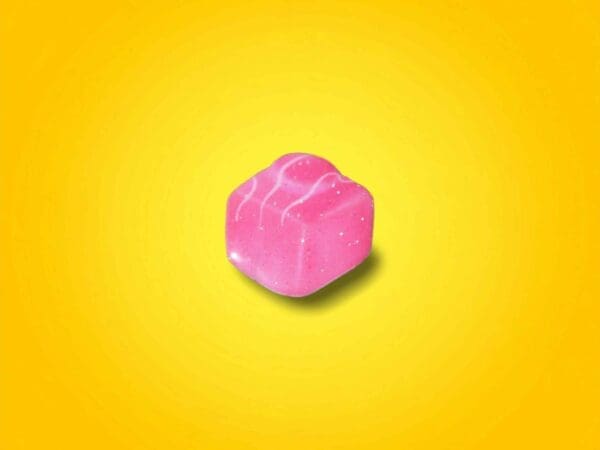 Pink French Fancy Pin Badge on a gradient yellow background.