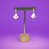 Polymer Clay Ghost earrings on a metal stand against a purple background.